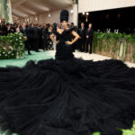 See Cardi B’s Met Gala Arrival as Nine Men Helped Carry Rapper’s Massive Black Gown