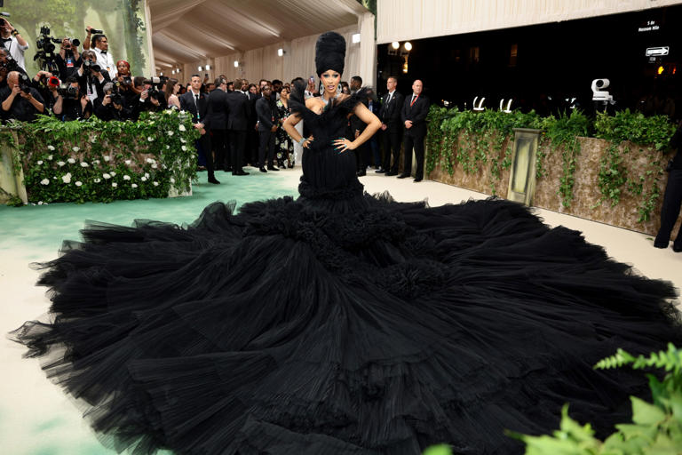 See Cardi B’s Met Gala Arrival as Nine Men Helped Carry Rapper’s Massive Black Gown
